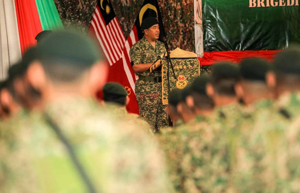 Director General of Defence Intelligence and Chairman of the KRD, General Datuk Ahmad Norihan Jalal, addresses troops during a retirement ceremony