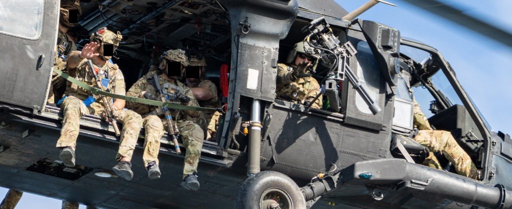 DEVGRU operators flying in a helicopter.