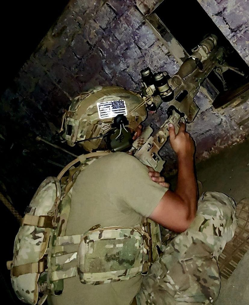 US soldier takes aim at night.